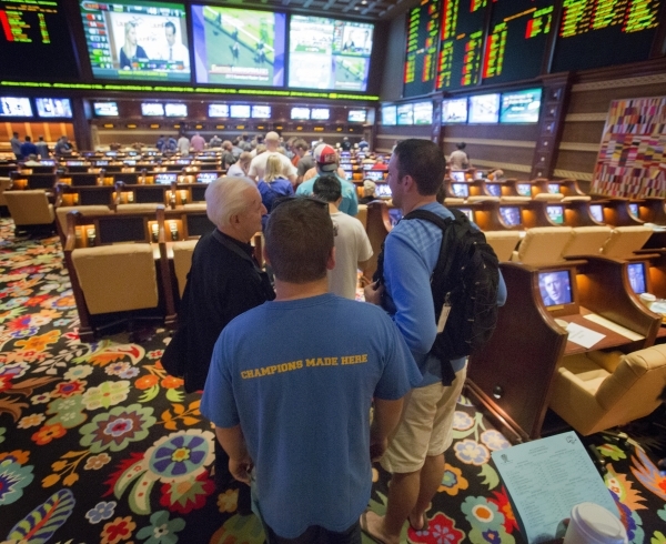 Bettors stand in line at Wynn Race and Sports Book during NCAA Men‘s basketball tournament  on Friday, March 21, 2014. March Madness betting is expected to generate a sports book handle of $ ...
