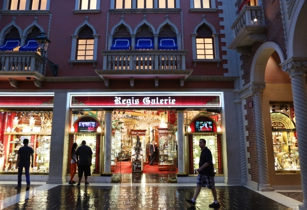 People window shop as they walk by Regis Galerie, located inside the Grand Canal Shoppes at The Venetian, on July 24. The gallery, which has a variety of unique artwork, jewelry, lighting and coll ...