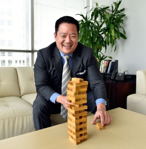 Kai-Shing Tao, CEO of Remark Media, plays the game Jenga while sitting his Las Vegas office on Tuesday, Aug. 25, 2015. Remark Media, a digital media company focusing on the 18- to 34-year-old age  ...