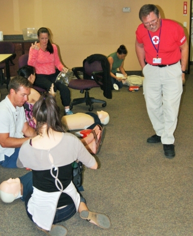 Scott Emerson, CEO of the American Red Cross, Southern Nevada chapter, instructs a class on the technique for chest compression. (Garrison Wells, Business of Medicine)