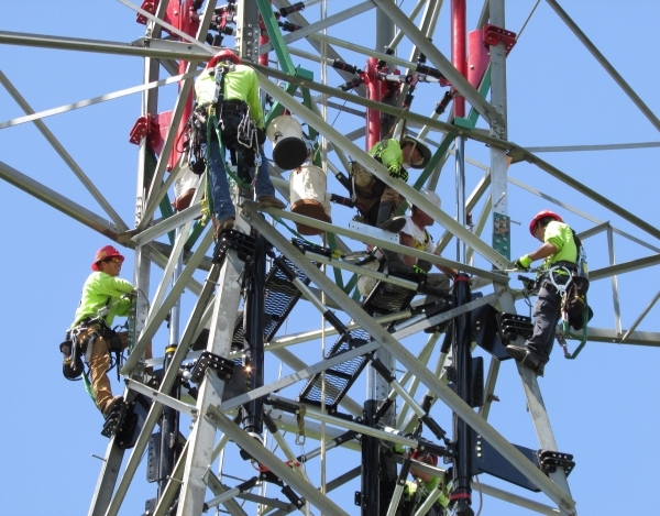 An Ampjack America crew works on raising the height of a power transmission tower without a crane and without disrupting service. (Courtesy, Ampjack America)  Undated, October, 2015