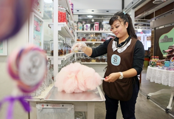 Arlene Bordinhao, co-owner of B Sweet Candy Boutique, sprinkles edible glitter onto cotton candy she finished spinning at B Sweet Candy Boutique Friday, Nov. 6, 2015, in Las Vegas. The local sweet ...