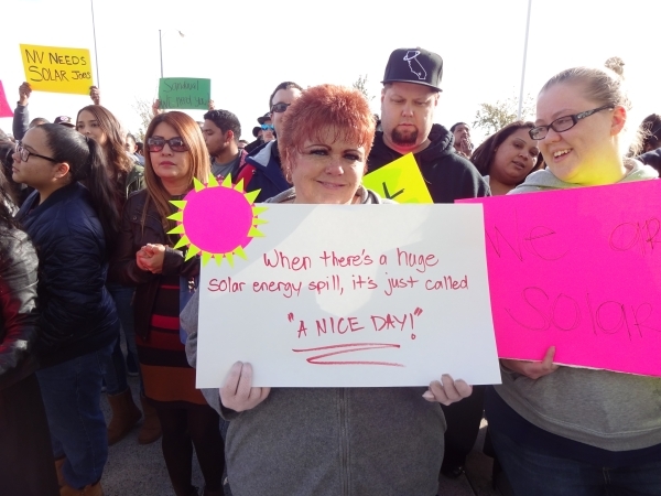 A protestor makes her point about solar energy outside a Public Utilities Commission meeting in Las Vegas Jan. 13. (Craig A. Ruark, special to the Las Vegas Business Press)