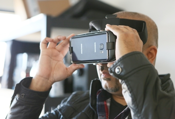 Fraser Almeida, creative director at Luxury Estates International, sets up a virtual marketing application that is viewed through 3D virtual reality goggles at Luxury Estates International Thursda ...
