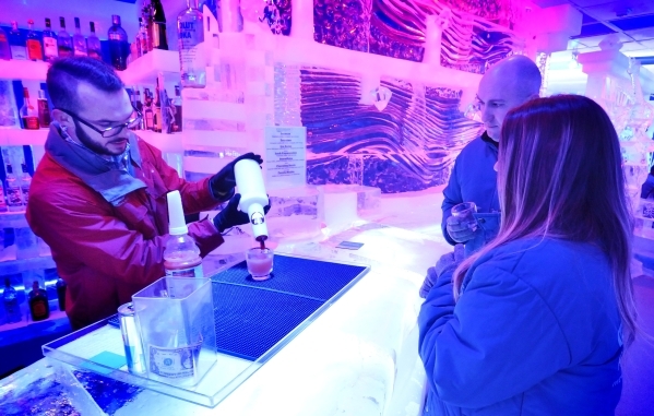 Bartender Kyle Adams, left, mixes a drink for Chris Maupin, center, and Lindsey Perry at the Minus5 Ice Bar in The Shoppes at Mandalay Place at 3930 Las Vegas Blvd. S. on Friday, Feb. 5, 2016. Bil ...