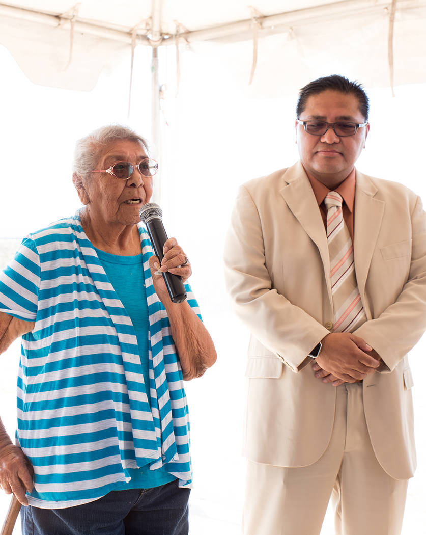 Juanita Kinlichinie, an elder of the Moapa Band of Paiutes, says a prayer in her native language to bless the Moapa Southern Paiute Solar facility while Darren Doboda, chairman of the tribal counc ...
