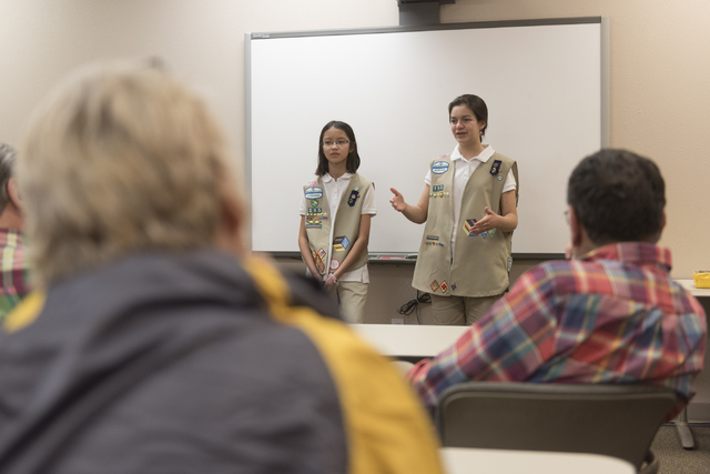 Isabella Ho, left, and Ashley de la Garza give a presentation to members of SCORE about the business of Girl Scout Cookies as part of the Girl Scouts CEO in Training program at the Urban Chamber o ...