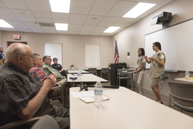 Isabella Ho, left, and Ashley de la Garza give a presentation to members of SCORE about the business of Girl Scout Cookies and the Girl Scouts CEO in Training program at the Urban Chamber of Comme ...