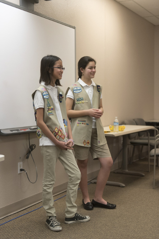 Isabella Ho, left, and Ashley de la Garza give a presentation to members of SCORE about the business of Girl Scout Cookies and the Girl Scouts CEO in Training program at the Urban Chamber of Comme ...