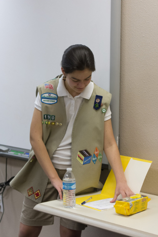 Ashley de la Garza grabs a Girl Scout Cookies order form during a presentation to members of SCORE about the business of Girl Scout Cookies and the Girl Scouts CEO in Training program at the Urban ...
