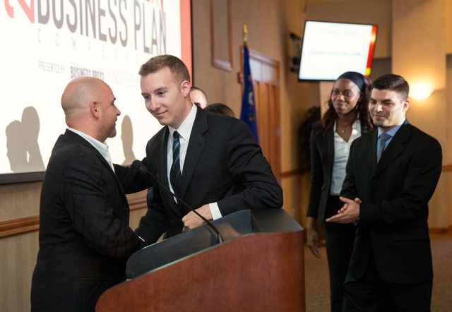 Dominic Anthony Marrocco, left, congratulates Greg Friesmuth, CEO and co-founder of Skyworks Aerial Systems, after announcing his team won the Dominic Anthony Marrocco Southern Nevada Business Pla ...