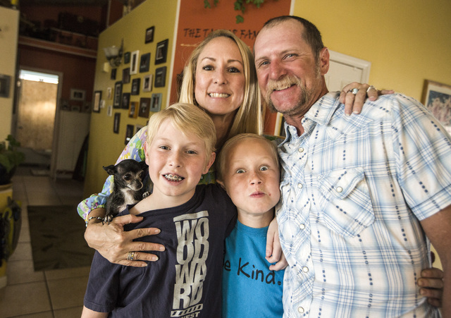 Shawn Taylor, right, with his family Bella the dog, left, Dalton, 11, left, wife Molly,  and Benjamin, 9, at their northwest Las Vegas home on Tuesday, March 31, 2015.  Taylor family is a microcos ...