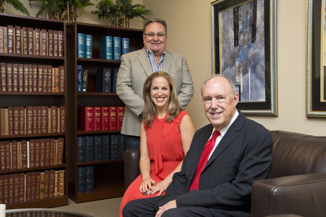 Attorneys Jeff Silver and Kate Lowenhar, seated, pose for a photo with Vic Salerno at the Dickinson Wright law offices in Las Vegas on Friday, June 24, 2016. Daniel Clark/Las Vegas Review-Journal  ...