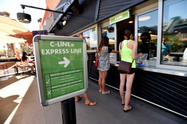 Customers place their order at the C-Line window at the Shake Shack restaurant at the New York-New York hotel-casino Monday, May 2, 2016, in Las Vegas. Customers may only purchase cold items from  ...