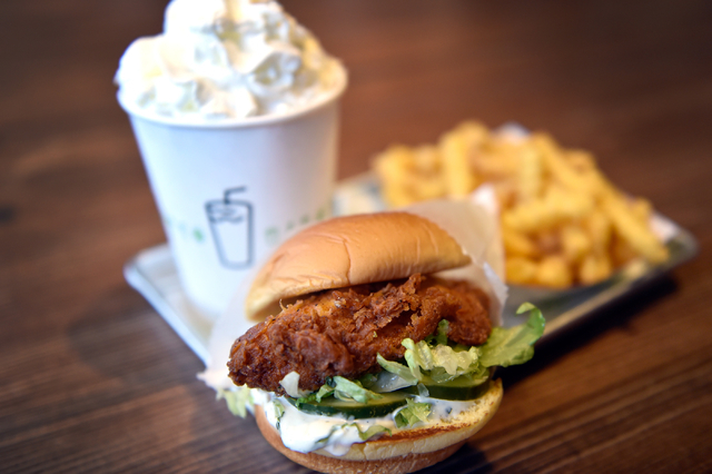 A Chick'n Shack sandwich meal with crinkle cut french fries and a whipped-cream topped chocolate shake is seen at the Shake Shack restaurant at the New York-New York hotel-casino Monday, May 2, 20 ...