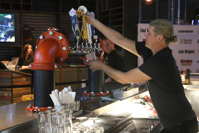 President and Managing Partner of Nacho Daddy Paul Hymas pours drinks behind the bar during the company's Strip restaurant's Aug. 17 grand opening. (Courtesy of Nacho Daddy)