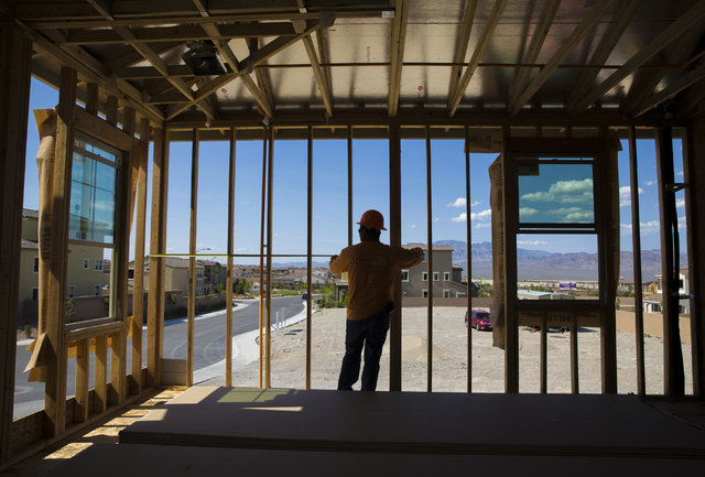 Jose Juarez measures a wall panel in a three-story home being constructed in Skye Canyon on May 23, 2016, in Las Vegas. (Benjamin Hager/Las Vegas Business Press)