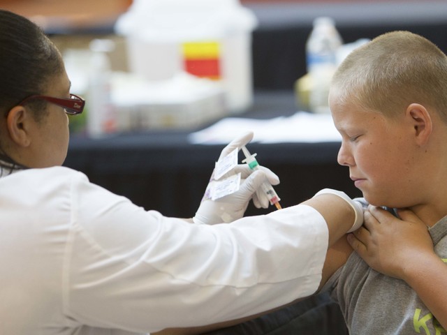 Las Vegas resident Devin Mansch, 11, receives an immunization shot from Nevada State College student nurse Tristen Wydeman. Nursing is one of the highest-paid professions in the Las Vegas valley.  ...