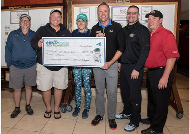 Shawn Duncan, Cox Communications vice president and board member with Boys and Girls Clubs of Southern Nevada (far left) presents a $25,000 check from Cox Charities to Andy Bischel, CEO of Boys an ...