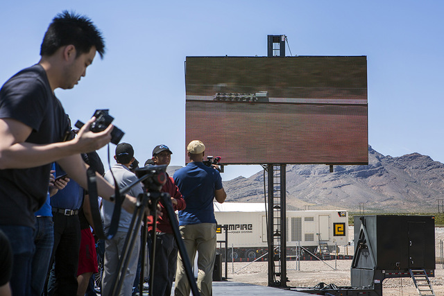 Media and invited guests view a video replay of the Hyperloop One test vehicle propelling down a set of tracks during its first public test at Apex on May 11. (Jeff Scheid/Las Vegas Business Press)
