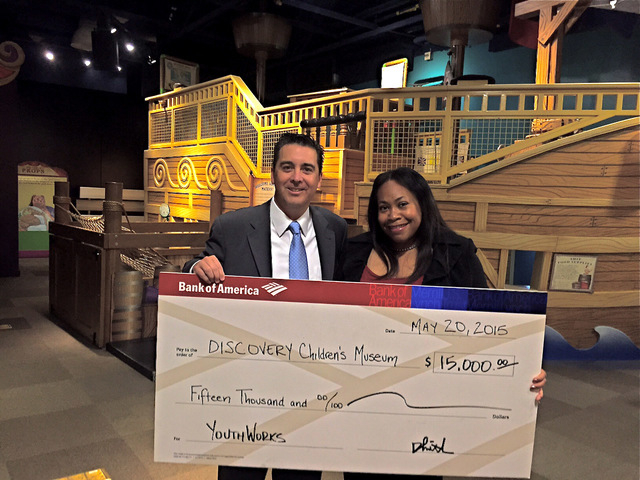 Don Giraldo, Bank of America’s Las Vegas market manager, presents one of 16 checks from the B of A's Charitable Foundation to Tifferney White, CEO of Discovery Children's Museum.