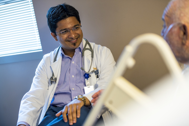 Dr. Vishal Shah, a hospitalist at Spring Valley Hospital Medical Center, talks with a patient at the hospital. (Joshua Dahl/Las Vegas Review-Journal)