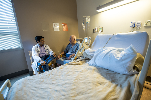 Dr. Vishal Shah, a hospitalist at Spring Valley Hospital Medical Center, left, talks with a patient at the hospital Thursday, June 4, 2015. (Joshua Dahl/Las Vegas Review-Journal)