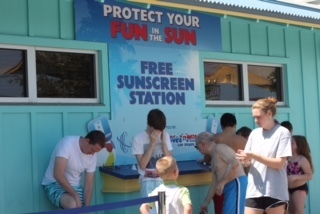 Wet 'n Wild guests apply free sunscreen as part of a promotion with the Comprehensive Cancer Centers of Nevada. The park says it goes through a gallon of sunscreen a day. (Courtesy)