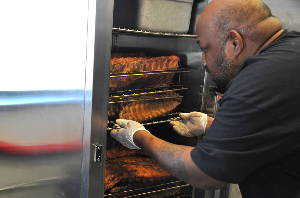 Michael Harris, co-owner of Tennesseasonings with wife Laura Harris, checks pork ribs for the day's service. Photo by Buford Davis / Las Vegas Business Press
