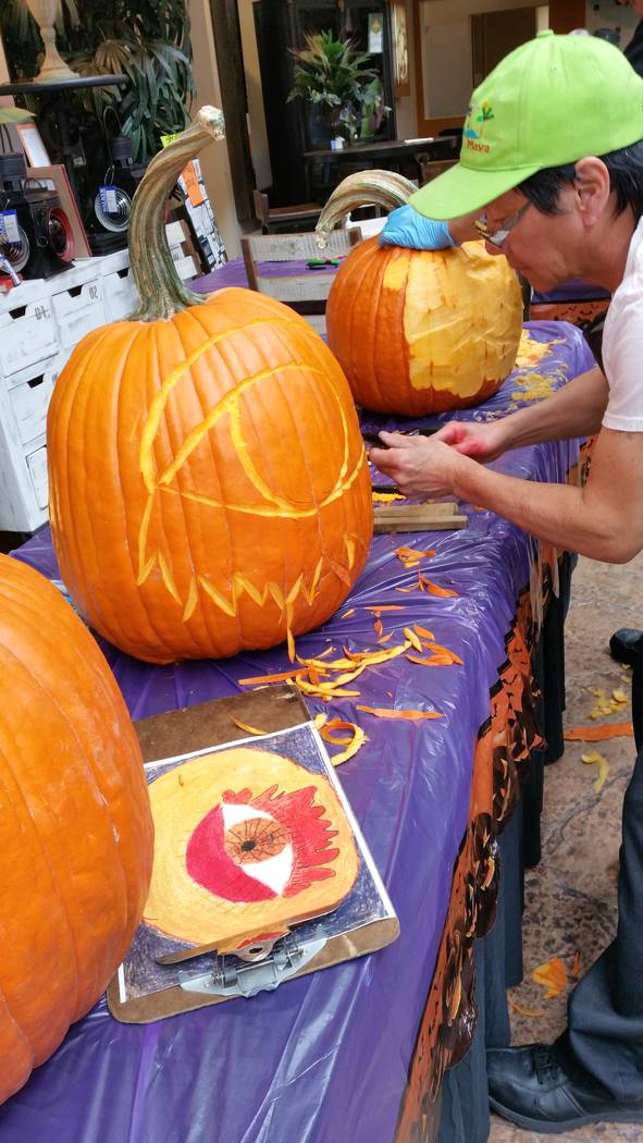 Chef Chanh Boupha carving pumpkins at Walker Furniture pumpkin drawing contest. (Courtesy)