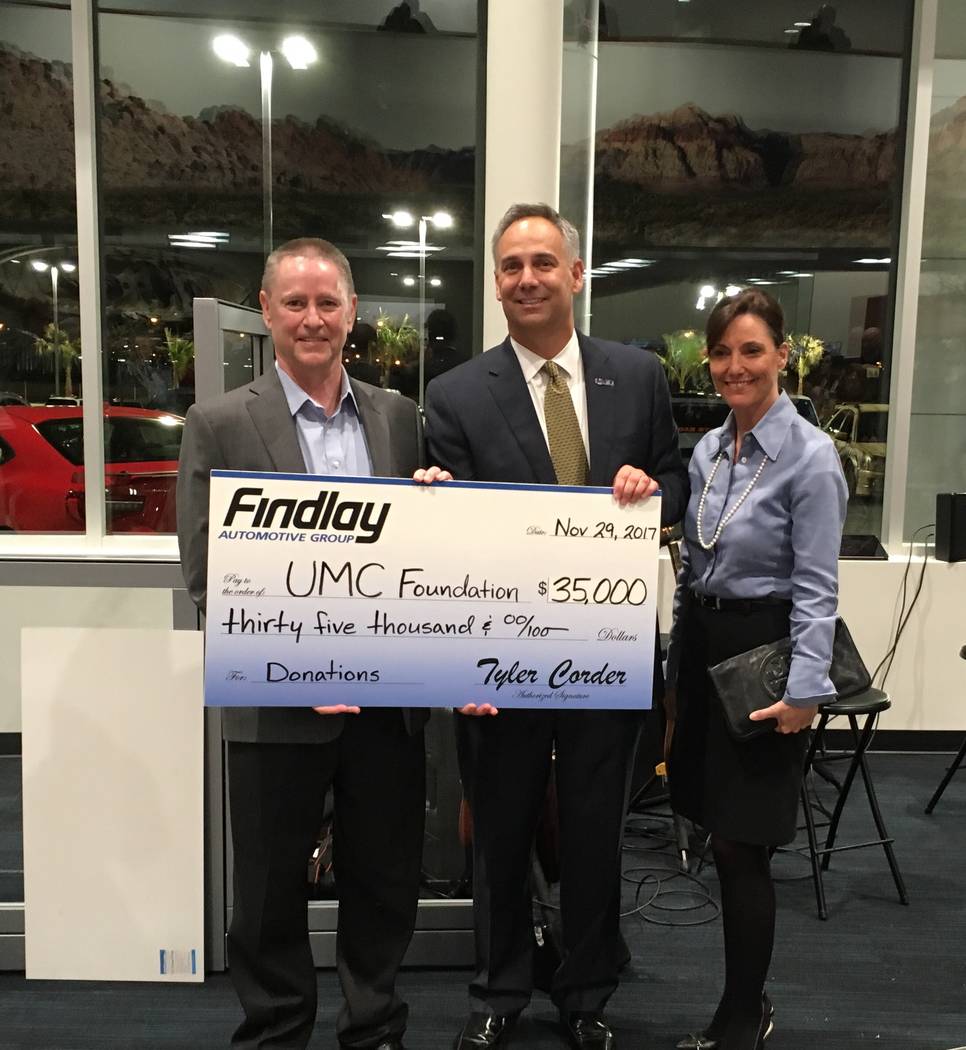 Findlay Automotive Group CFO Tyler Corder, left, presents a check for $35,000 to Mason Van Houweling, UMC CEO; and Marcia Turner, chief administrative officer for UMC. (Courtesy)