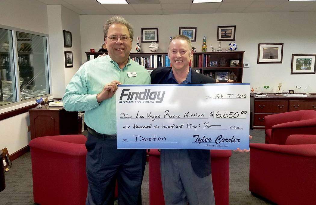 Findlay Automotive Group Chief Financial Officer Tyler Corder, right, presents a check to Harry Hinderliter, president and CEO of Las Vegas Rescue Mission.  (Findlay Automotive Group)
