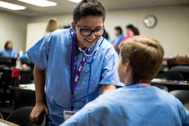 Brian Munoz, a CampMed participant, takes a fellow student's heart beat during a radiology session at UNLV. (Elizabeth Brumley Business of Medicine)