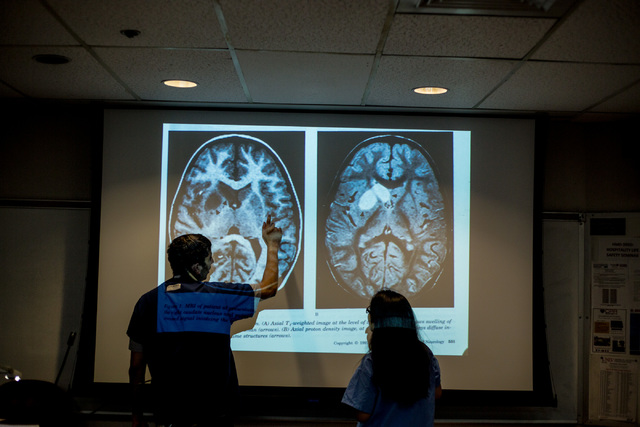 Dr. Kalyan Tatiney, left, points at different parts of a brain to CampMed participant Khaya Mae Tawatao at UNLV in Frank and Estella Beam Hall. (Elizabeth Brumley Business of Medicine)