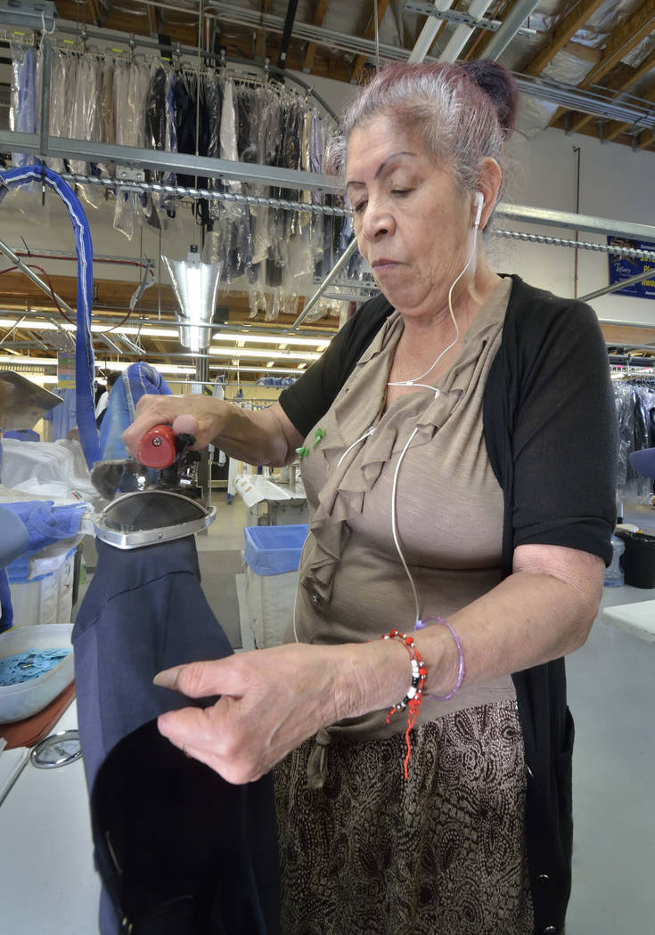 Silk presser Francesca Minjarez works in the cleaning and pressing area at Tiffany Couture Cleaners. (Bill Hughes Las Vegas Business Press)