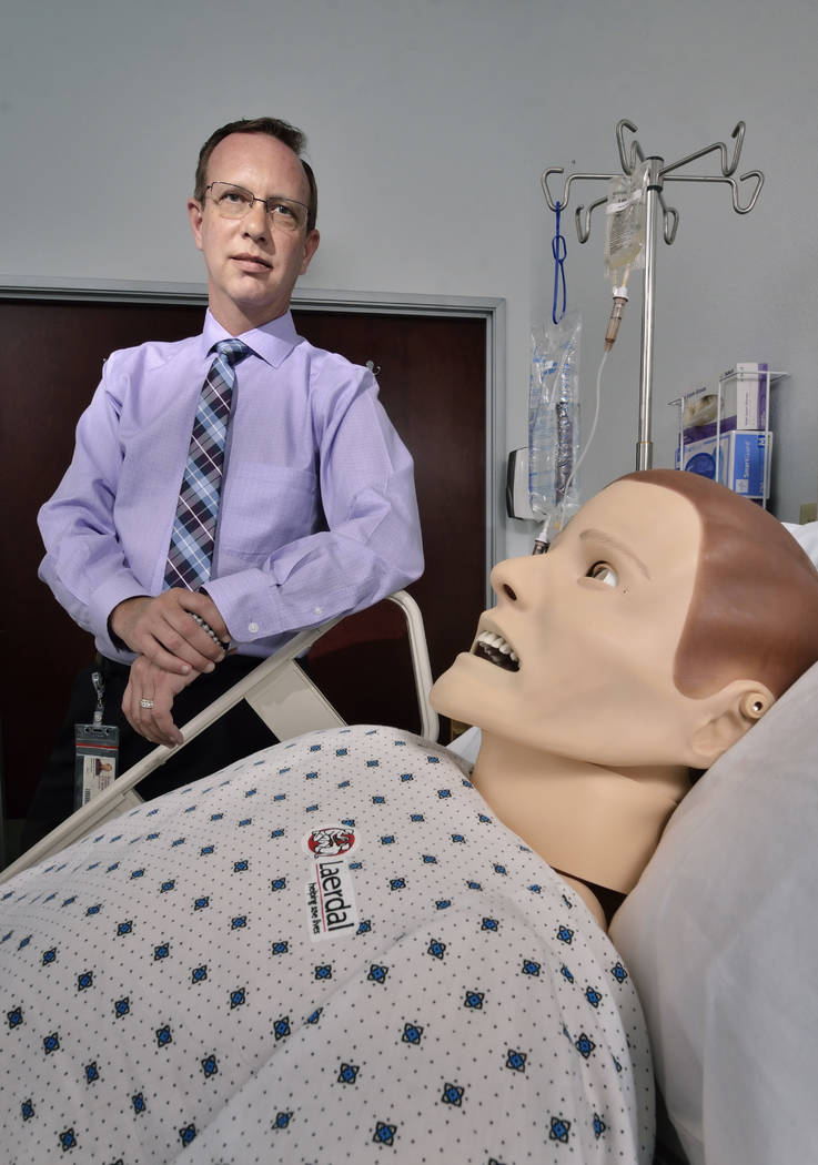 Delos Jones, director of clinical resources at Roseman University of Health Sciences, is shown with Sim Man, a computerized mannequin. (Bill Hughes Las Vegas Business Press)