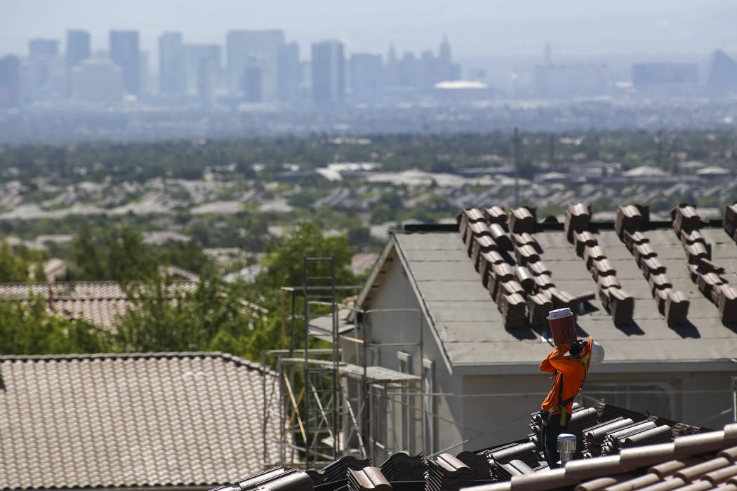 A roofer quenches his thirst while doing tile work on a house in the master-planned community of Summerlin. (Richard Brian Las Vegas Business Press)