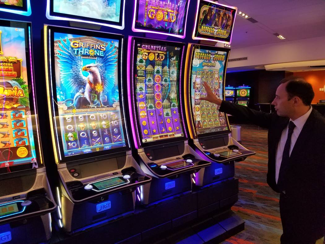 Nick Khin, IGT’s chief commercial officer for gaming, checks out IGT's large format Celestial Towers of Gold slot machine. It was featured at this week's Global Gaming Expo. (Richard N. Velotta ...