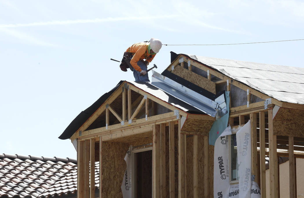 A construction worker puts a roof on a new home at the Cove at Southern Highlands and St. Rose parkways on April 18. (Bizuayehu Tesfaye/Las Vegas Business Press)
