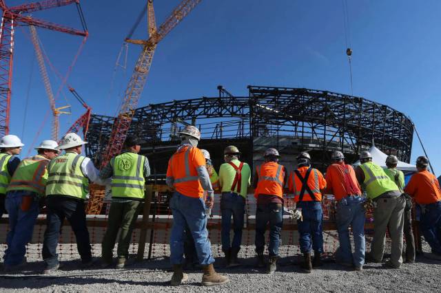 In this Aug. 5 photo, workers attend the Las Vegas Stadium Topping Out Ceremony in Las Vegas. ( ...