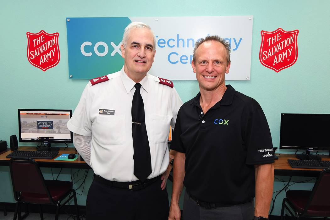 From left, Major Randy Kinnamon, Salvation Army, and David Diers, Cox Communications.