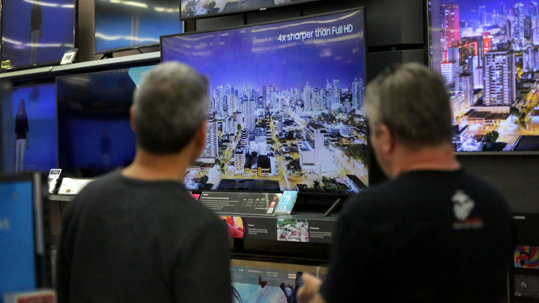 Brothers Robert, left, and Joe Seeburger check out high-resolution LED TVs at Walmart on Nov. 2 ...