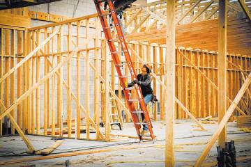 This file photo shows a worker at a new-home construction site. Local homebuilders just posted ...