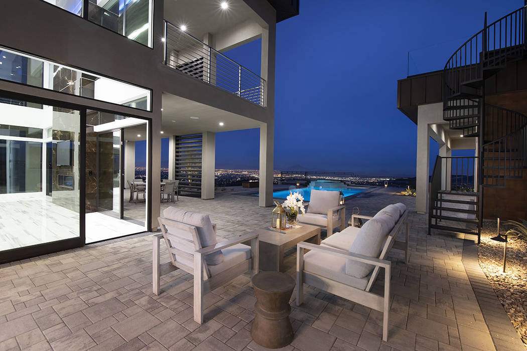 A sitting area is near the pool. (Synergy Sotheby’s International Realty)