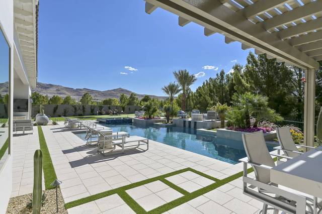 Nartey/Wilner Group, Simply Vegas The home's backyard, features a pool and spa and barbecue area.