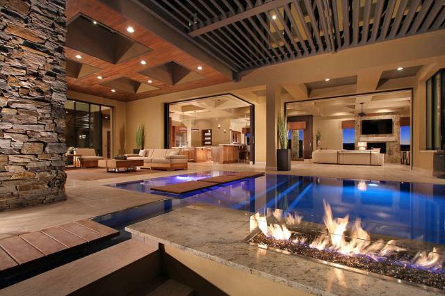 This MacDonald Highlands mansion features a pool that flows up to indoor/outdoor living spaces. ...