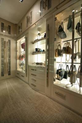 A closet in the master bedroom has a vitrine for displaying handbags as if they were art. (Syne ...