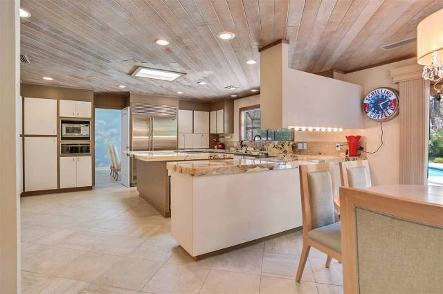 The updated kitchen in Andrew Dice Clay's historical home has new granite, updated appliances a ...