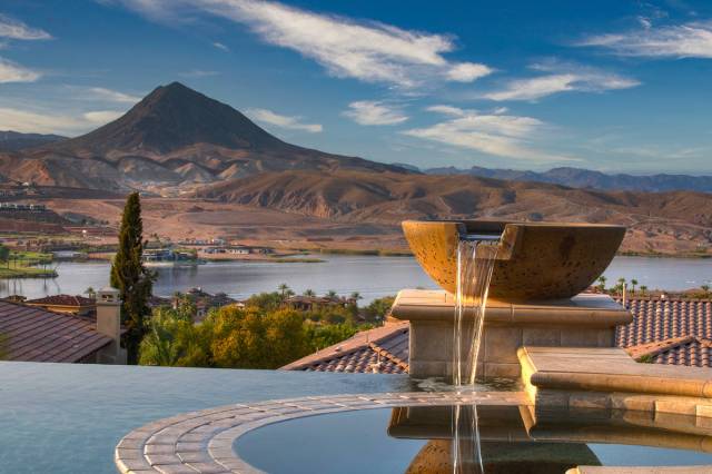 The Lake Las Vegas home's pool area has water features and striking views of the lake and mount ...