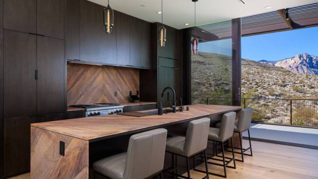 The upstairs kitchen has upgraded Wolf and Sub-Zero appliances and an island with seating. (The ...